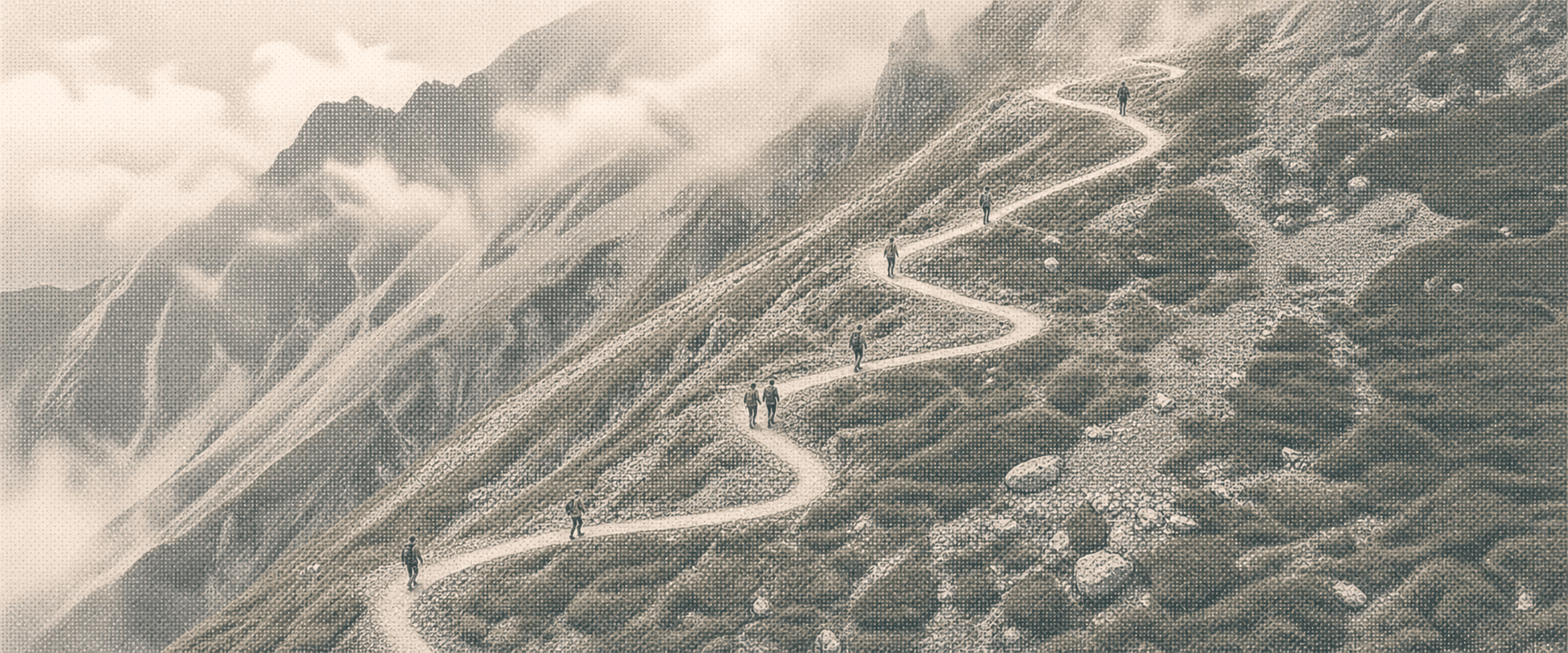 An aerial view of hikers ascending a mountain switchback trail